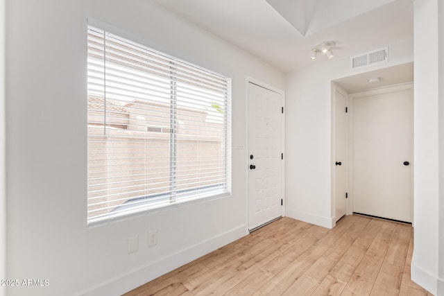entrance foyer featuring light wood-style floors, plenty of natural light, and baseboards