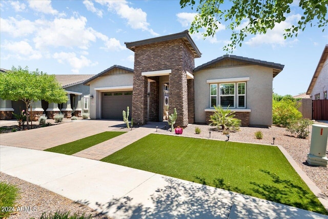 view of front of property with a garage and a front lawn