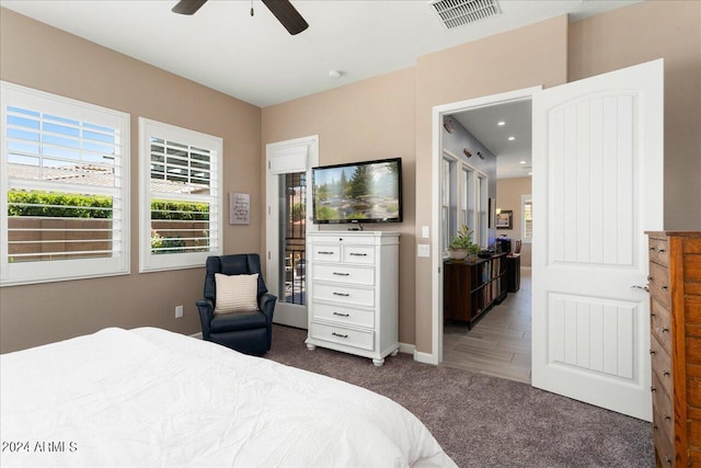 bedroom featuring dark colored carpet and ceiling fan