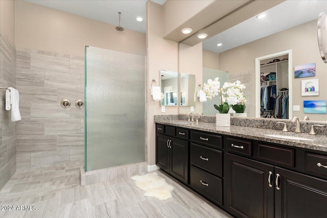 bathroom featuring vanity and tiled shower