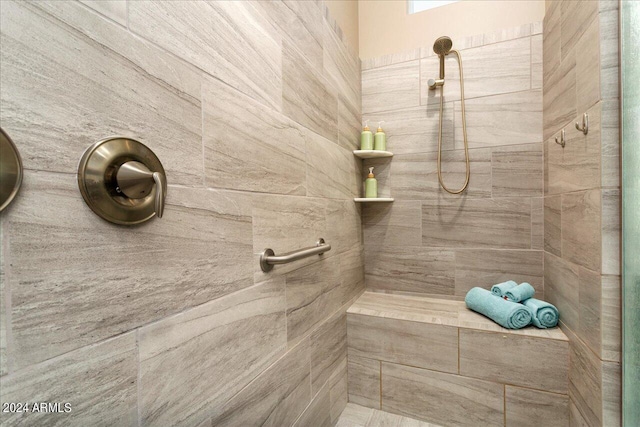 bathroom with tiled shower