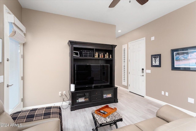 living room with ceiling fan and wood-type flooring