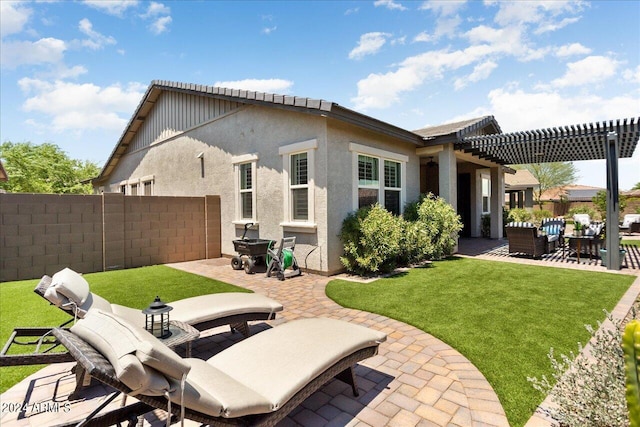 rear view of house with a yard, a pergola, and a patio area