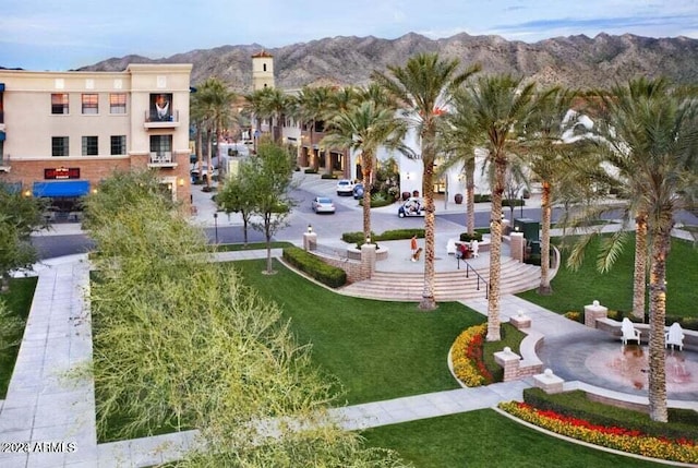 view of home's community featuring a mountain view and a lawn