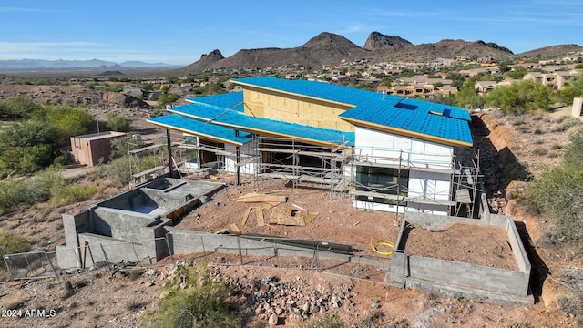 back of house featuring a mountain view and an outdoor structure