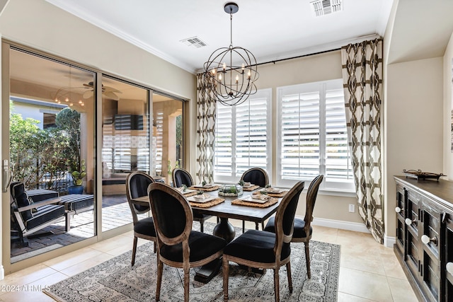 dining space with ceiling fan with notable chandelier, light tile patterned floors, and ornamental molding