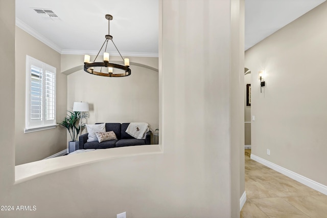 hallway with an inviting chandelier and crown molding