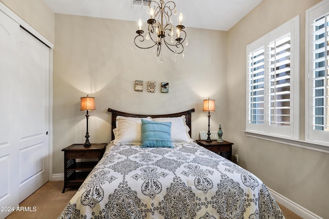 bedroom featuring carpet flooring, a closet, and a chandelier