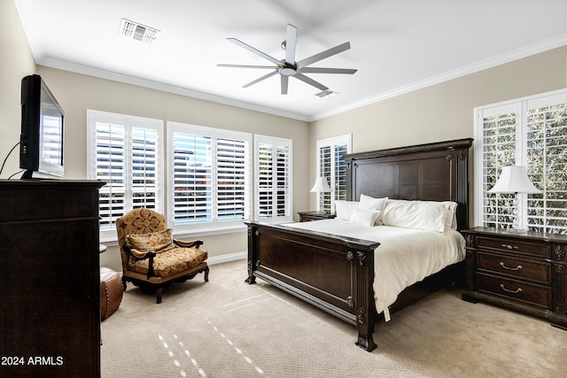 carpeted bedroom with multiple windows, ceiling fan, and ornamental molding