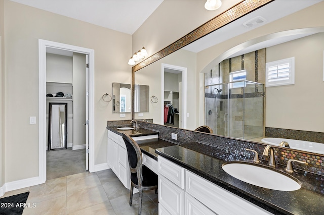 bathroom featuring tile patterned floors, vanity, and a shower with door