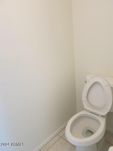 bathroom featuring toilet and tile patterned flooring