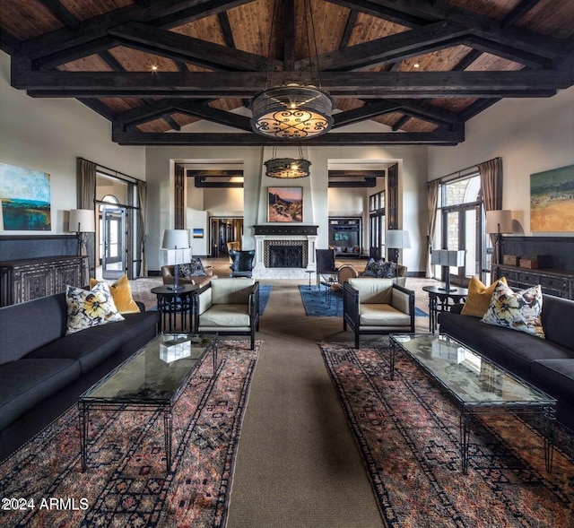 carpeted living room featuring wooden ceiling, beam ceiling, and high vaulted ceiling