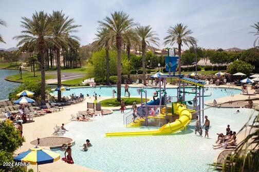 view of swimming pool with a water slide