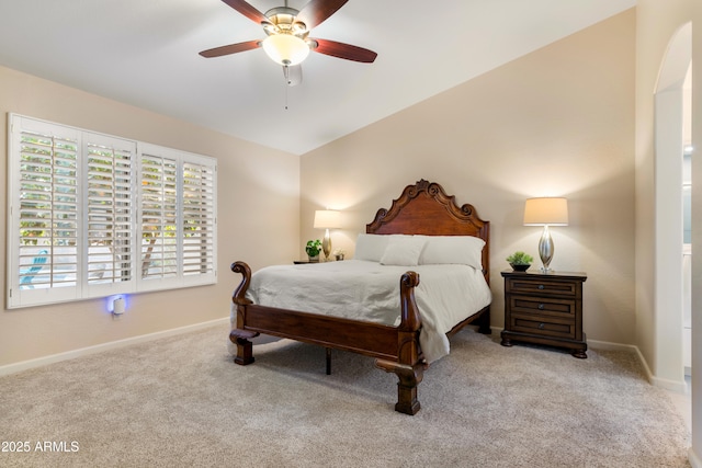 carpeted bedroom with vaulted ceiling and ceiling fan