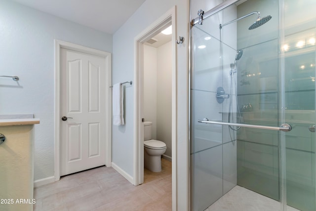 bathroom featuring an enclosed shower and toilet