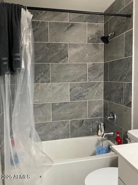 full bathroom with vanity, shower / bath combination with curtain, and toilet