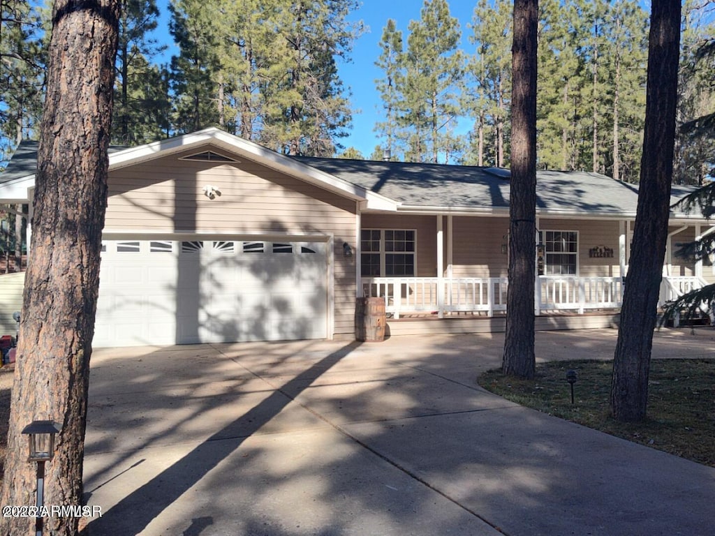 ranch-style home featuring a porch and a garage