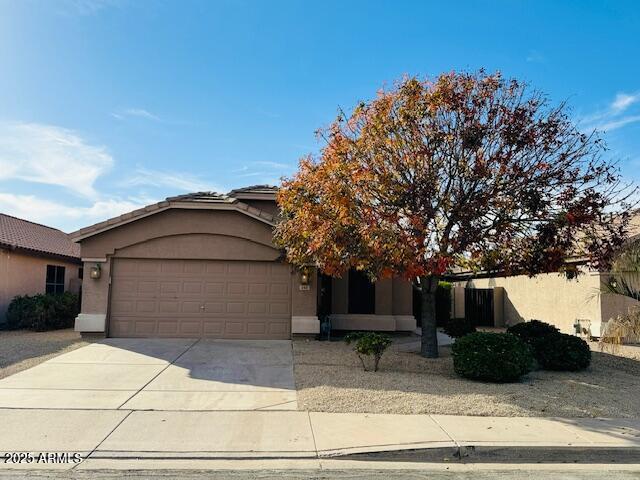 obstructed view of property with a garage