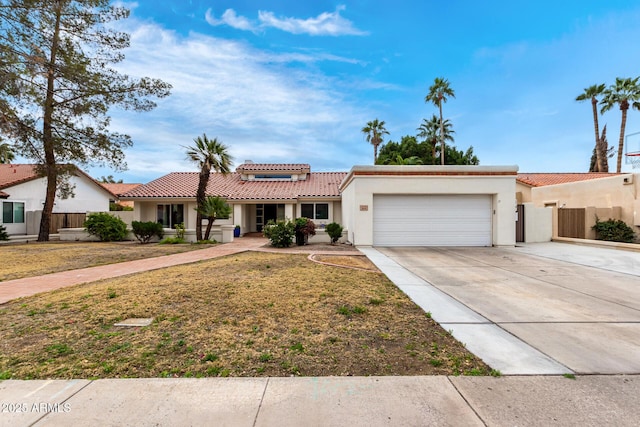 view of front of home with a garage and a front lawn