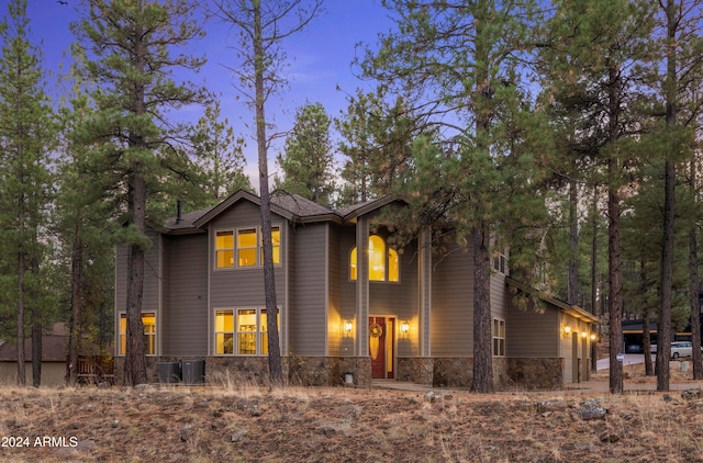 property exterior at dusk featuring central AC unit