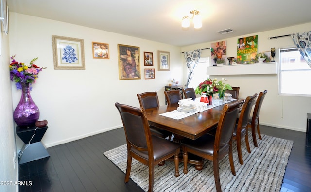 dining space with wood-type flooring and a healthy amount of sunlight