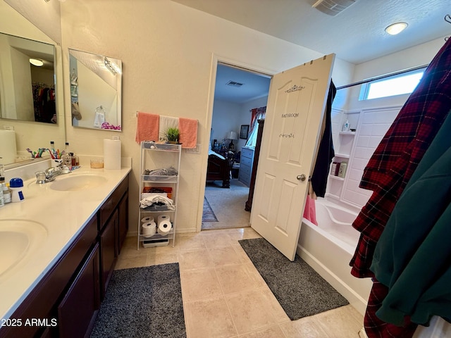 bathroom with shower / tub combo, vanity, and tile patterned flooring