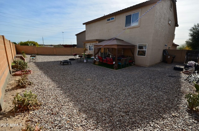 rear view of house featuring a gazebo and a patio