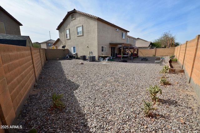 rear view of house featuring cooling unit and a patio area