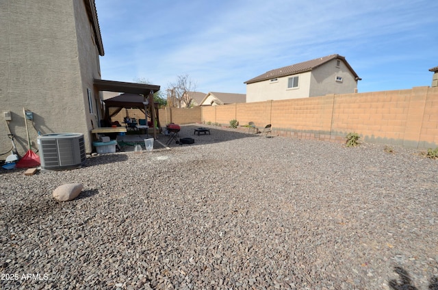 view of yard with central AC unit and a patio