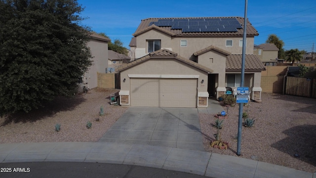 view of front of property with a garage and solar panels