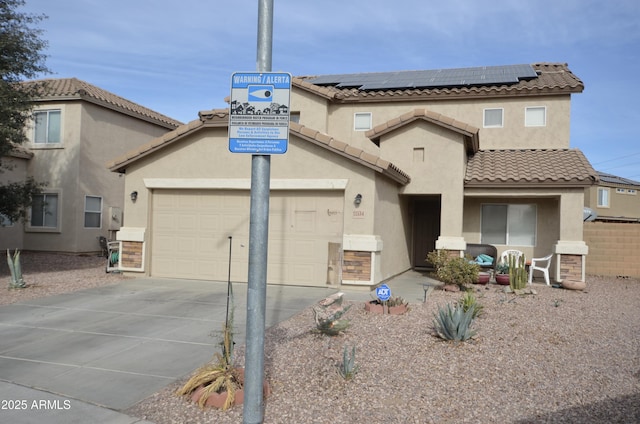 view of front of house featuring a garage and solar panels