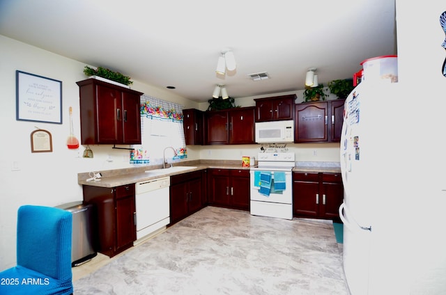 kitchen featuring sink and white appliances