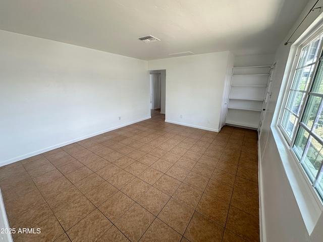2928 N 37th Ave, Phoenix, AZ 85019 - tiled empty room featuring baseboards