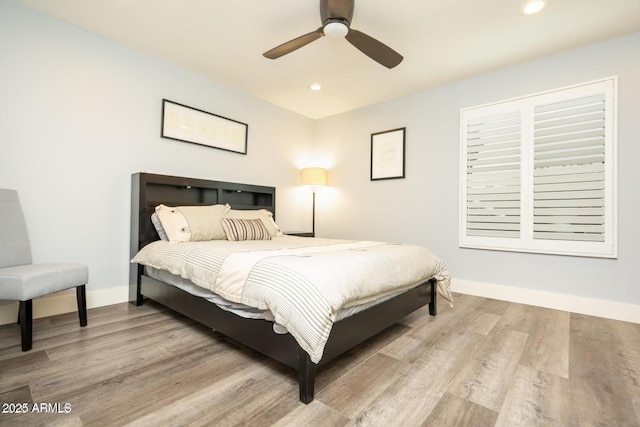 bedroom featuring ceiling fan, baseboards, wood finished floors, and recessed lighting