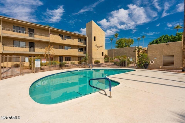 pool featuring a patio and fence