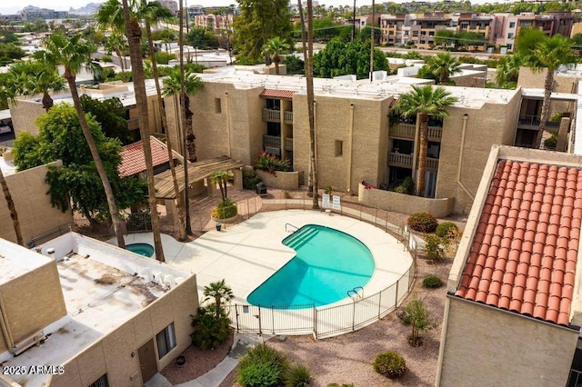 community pool featuring a patio area and fence