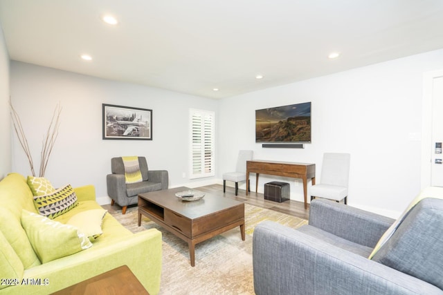 living room with light wood-style floors, baseboards, and recessed lighting