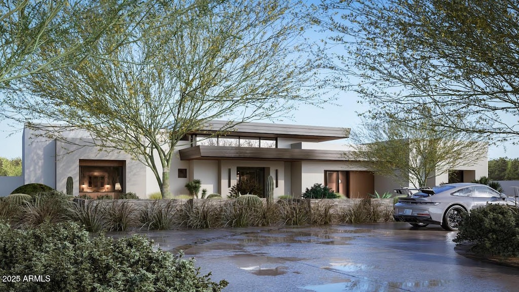 view of front of home featuring an outdoor fireplace and stucco siding