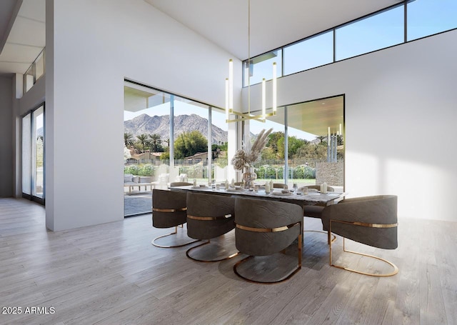 9790 N 56th St, Paradise Valley, AZ 85253 - dining area featuring wood finished floors, a mountain view, a towering ceiling, and a wall of windows