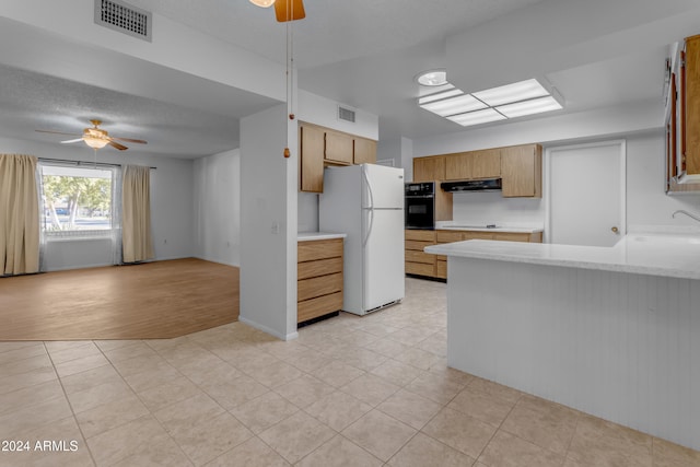 kitchen featuring black appliances, sink, ceiling fan, light tile patterned floors, and a textured ceiling