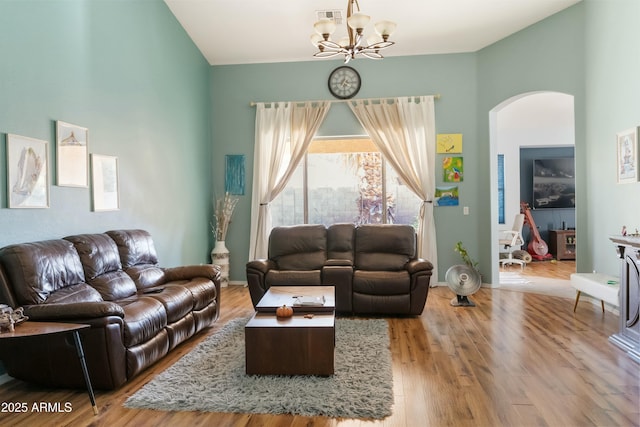 living room featuring a notable chandelier and light hardwood / wood-style flooring