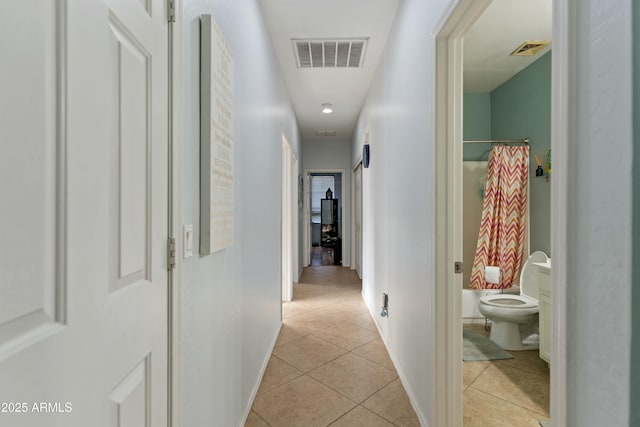 hall featuring light tile patterned floors