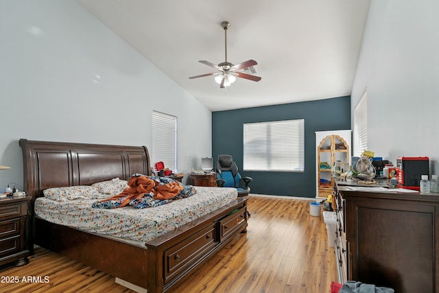 bedroom featuring vaulted ceiling, ceiling fan, and light hardwood / wood-style flooring