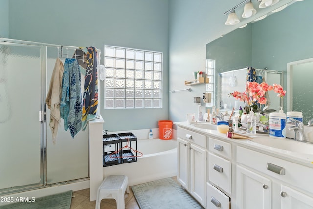 bathroom with plus walk in shower, vanity, and tile patterned floors