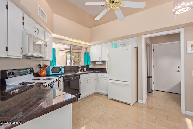 kitchen featuring ceiling fan, white cabinetry, dark stone counters, sink, and white appliances