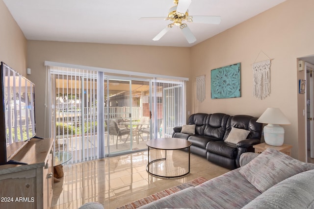 living room featuring vaulted ceiling, light tile patterned flooring, and ceiling fan