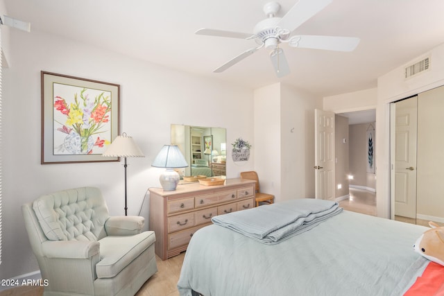 bedroom featuring a closet, light wood-type flooring, and ceiling fan