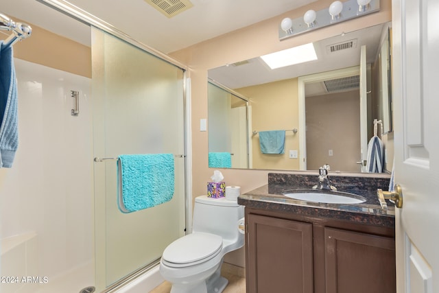 bathroom with toilet, a shower with shower door, and vanity