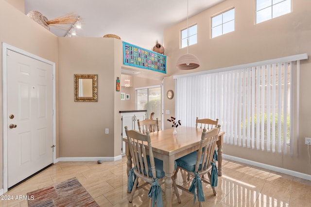 dining room featuring a towering ceiling