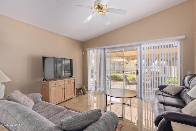 living room with ceiling fan, light tile patterned floors, and vaulted ceiling